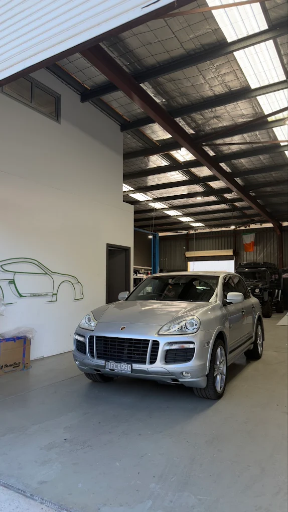 Purely Porscha workshop interior with Porsche Cayenne