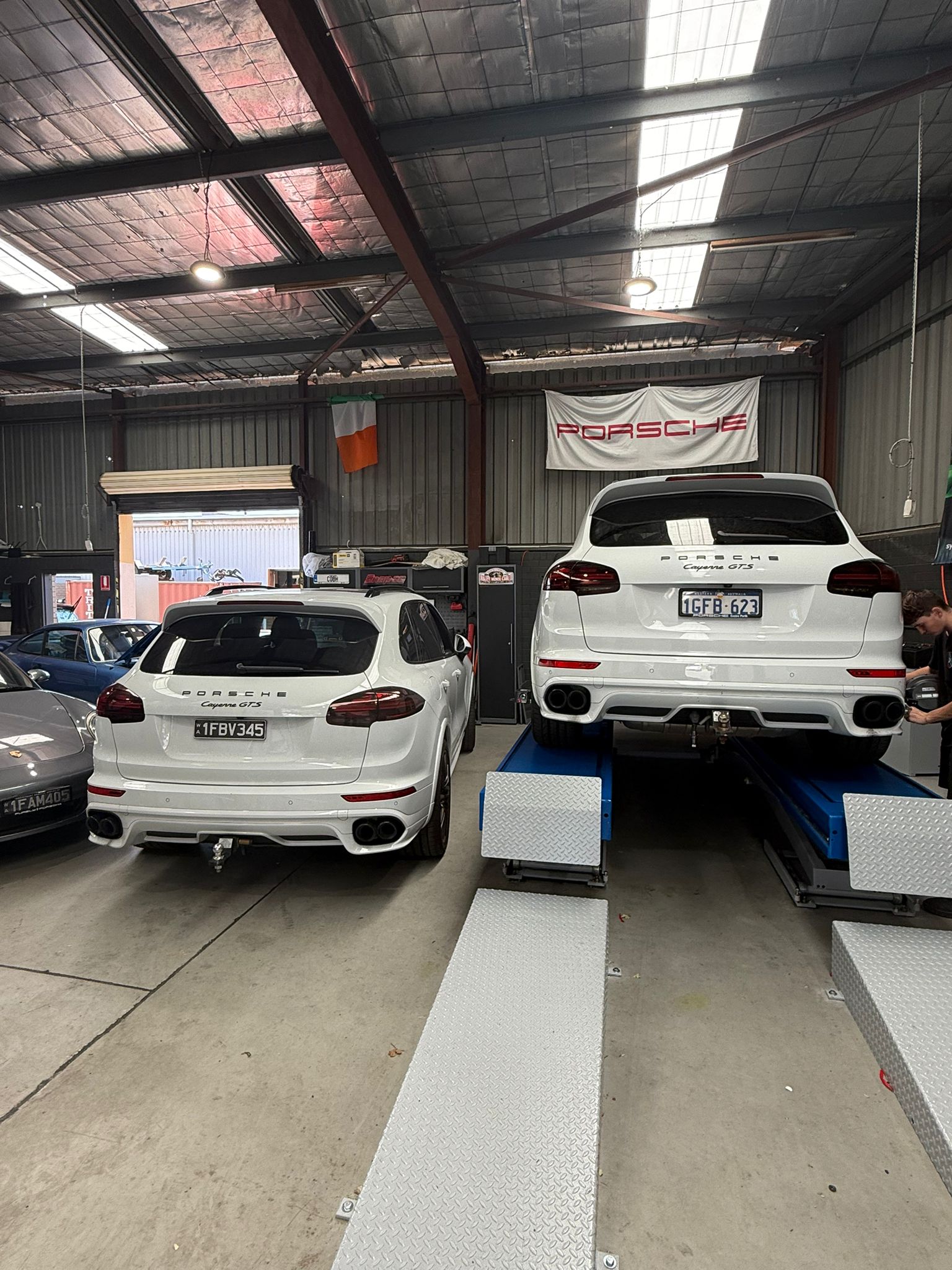 Purely Porscha workshop with Porsche Cayenne GTS on lift